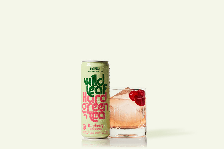 A can and glass of Raspberry Wild Leaf Hard Green Tea