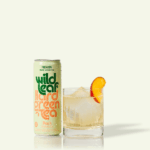 A can and glass of Peach Wild Leaf Hard Green Tea