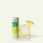 A can and glass of Pineapple Wild Leaf Hard Green Tea