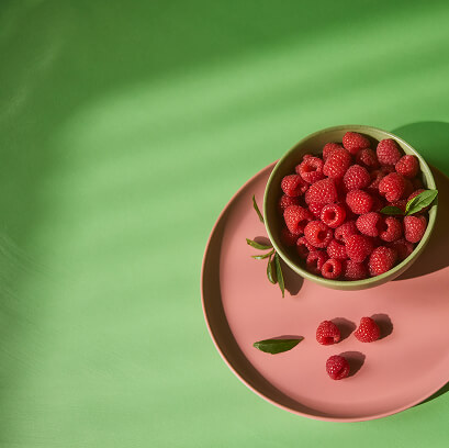 An overhead view of a bowl of raspberries